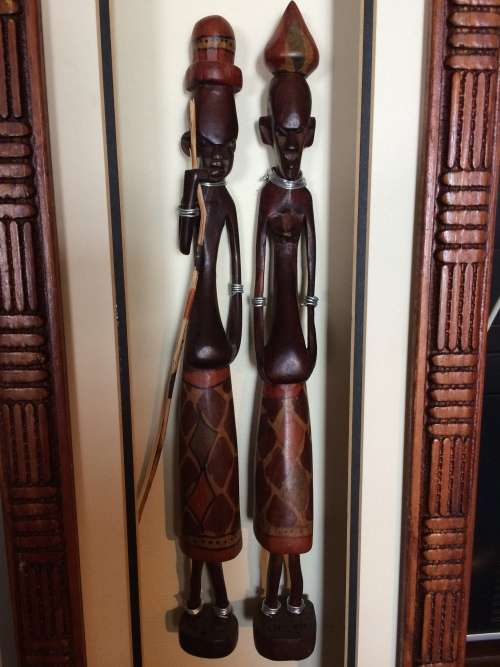 Tribal  carved figures in frame